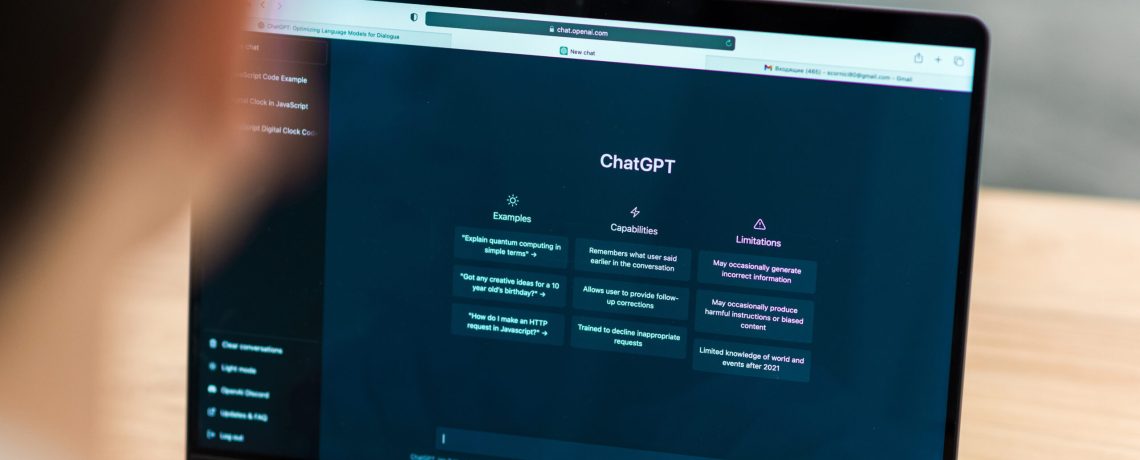 Close view of a man with opened AI chat on laptop