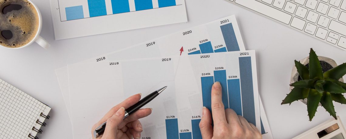 4 - top-view-office-desk-with-growth-chart-hands