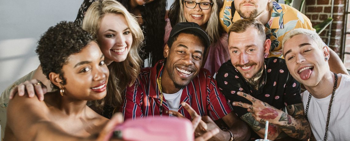 Diverse group of friends taking a selfie at a party